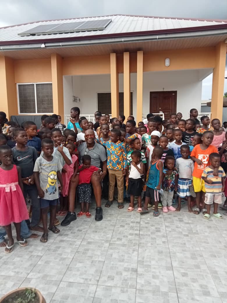 Mr Kofi with children in Ghana